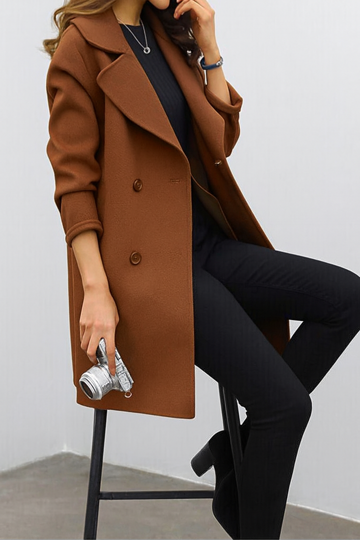 Elegant women's double-breasted long trench coat featuring a prominent lapel, ideal for winter style outerwear.