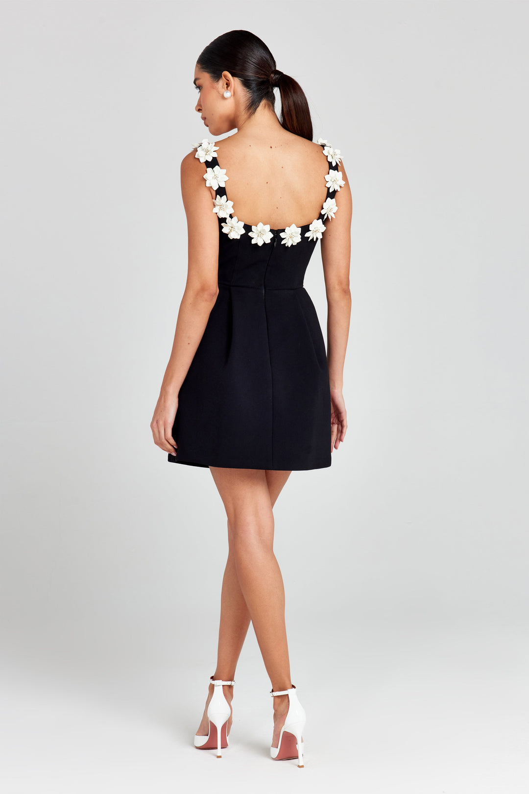 Beautiful women's floral appliqué summer mini dress. Chic A-line style with practical pockets.