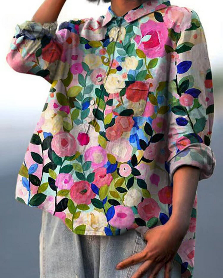 Women's elegant floral summer blouse, a relaxed fit top for casual and feminine wear.
