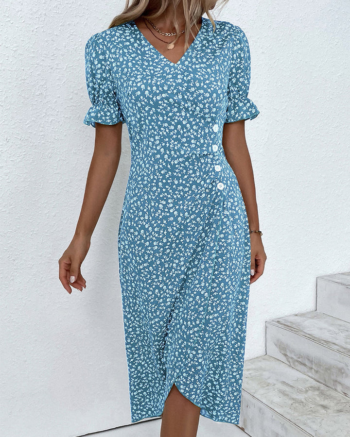 Side profile of a woman wearing a flattering floral v-neck dress, highlighting its elegant midi silhouette.