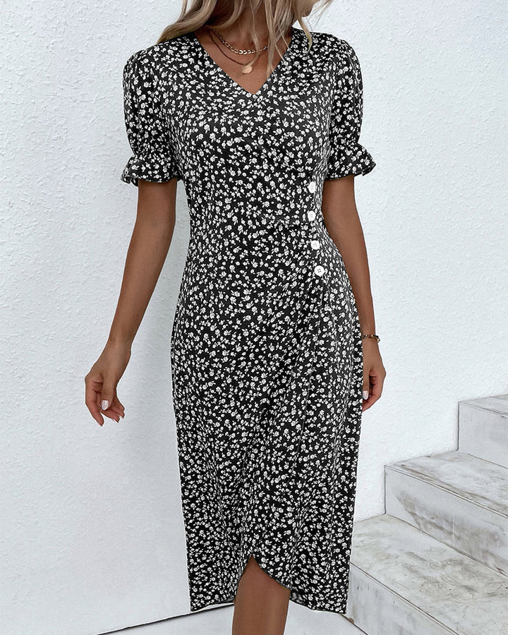 Elegant woman in chic floral v-neck midi dress, ideal for sophisticated spring and summer occasions.