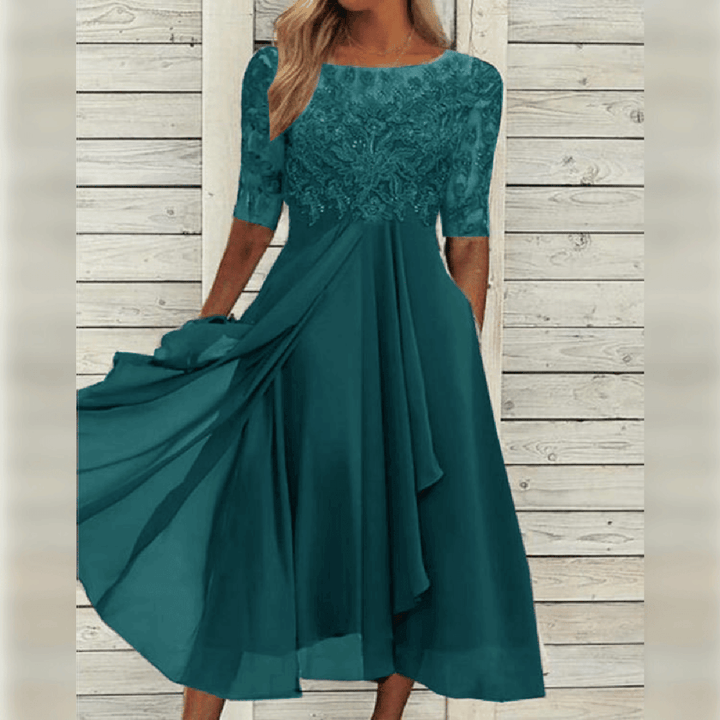 Woman modelling a beautiful lace bodice midi dress, perfect for cocktail parties and evening wear.