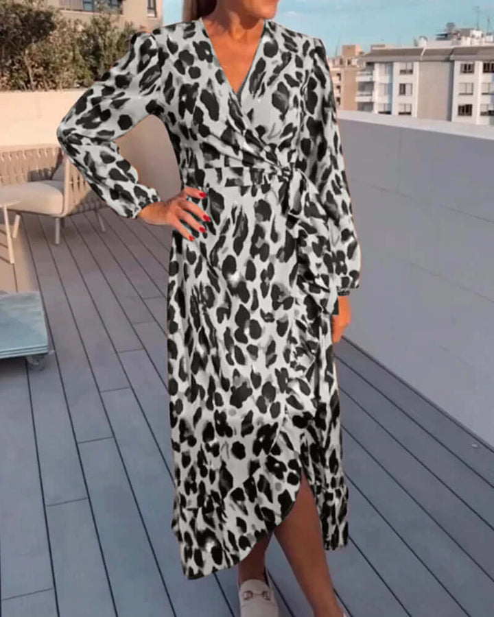 Fashionable woman wearing a V-neck leopard print midi dress, an elegant and casual animal print outfit.
