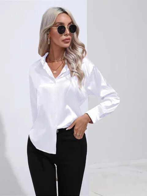Luxury women's apparel: an elegant loose fit satin blouse with chic long sleeves.
