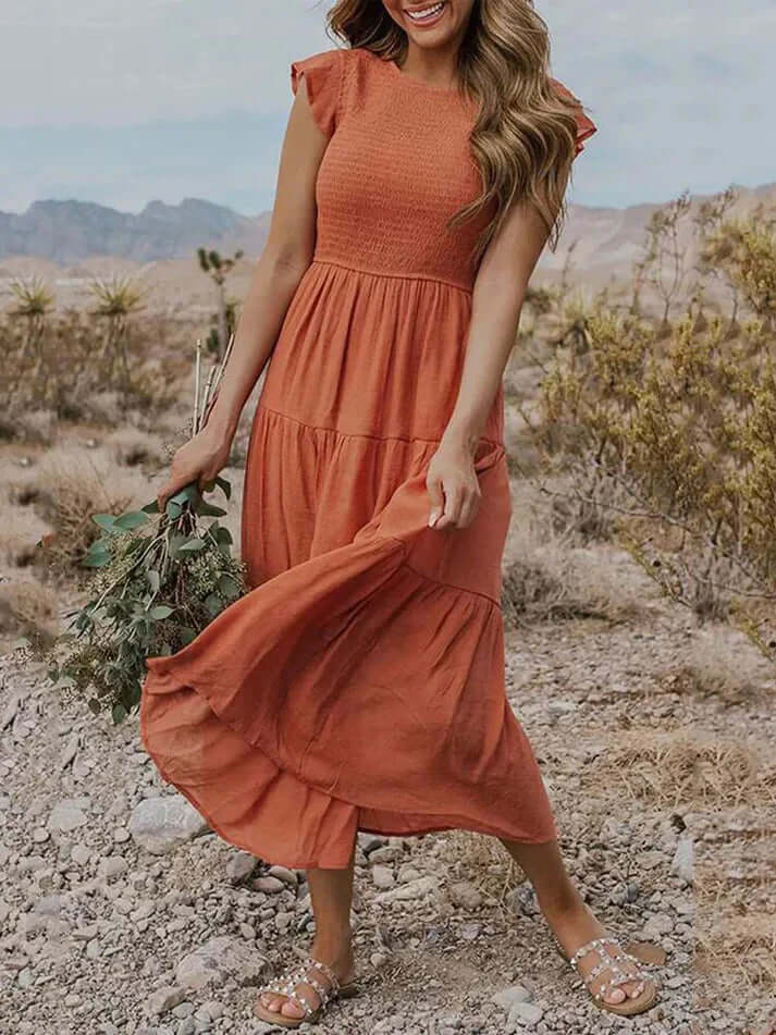 Women's elegant pleated A-line midi dress with delicate flutter sleeves, perfect for summer occasions. Versatile fashion.