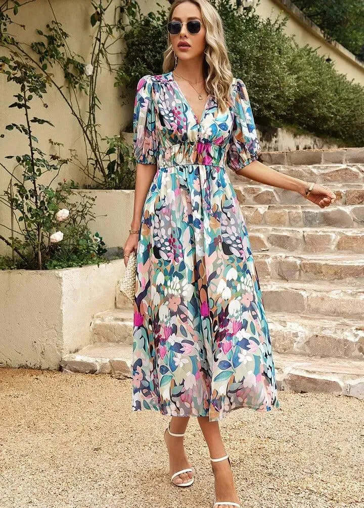 Women's spring/summer midi dress. Elegant with puff sleeves, a cinched waist, V-neck, & unique abstract print.