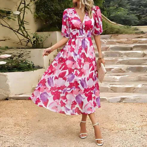 Stylish women's midi dress for spring. Features puff sleeves, cinched waist, V-neck, and a vibrant abstract print.