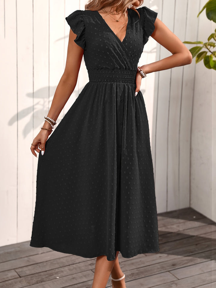 Flowy women's black midi dress, V-neck, ruffle sleeves, smocked waist, and dotted pattern. Perfect for day.