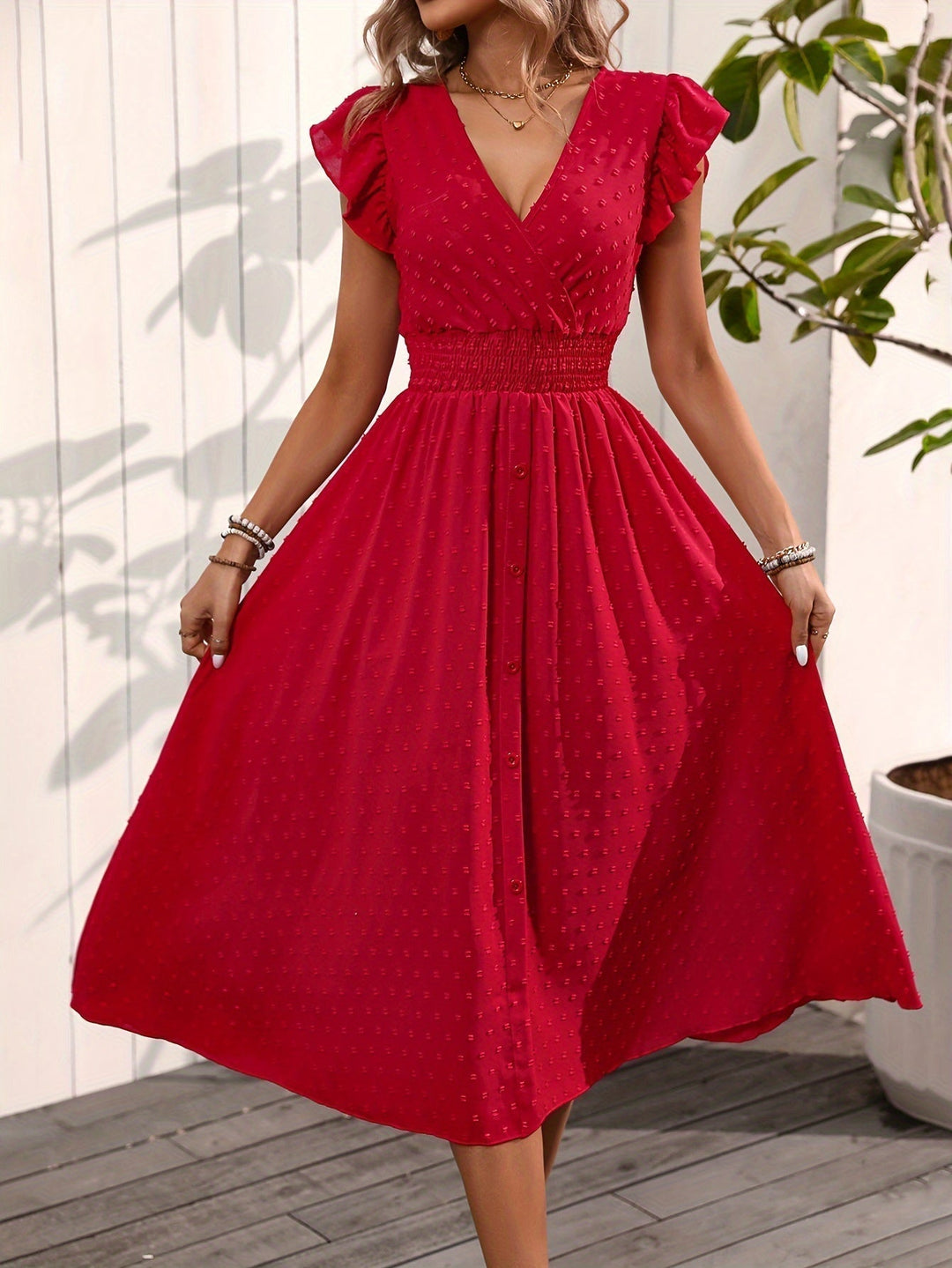 Elegant women's V-neck midi dress with ruffle sleeves, smocked waist, and dotted pattern for ladies fashion.