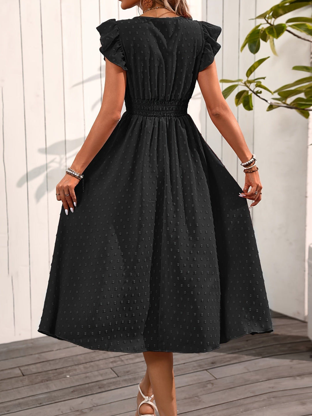 Red women's V-neck midi dress, ruffle sleeves, smocked waist, & dotted pattern. Flowy and elegant ladies fashion.