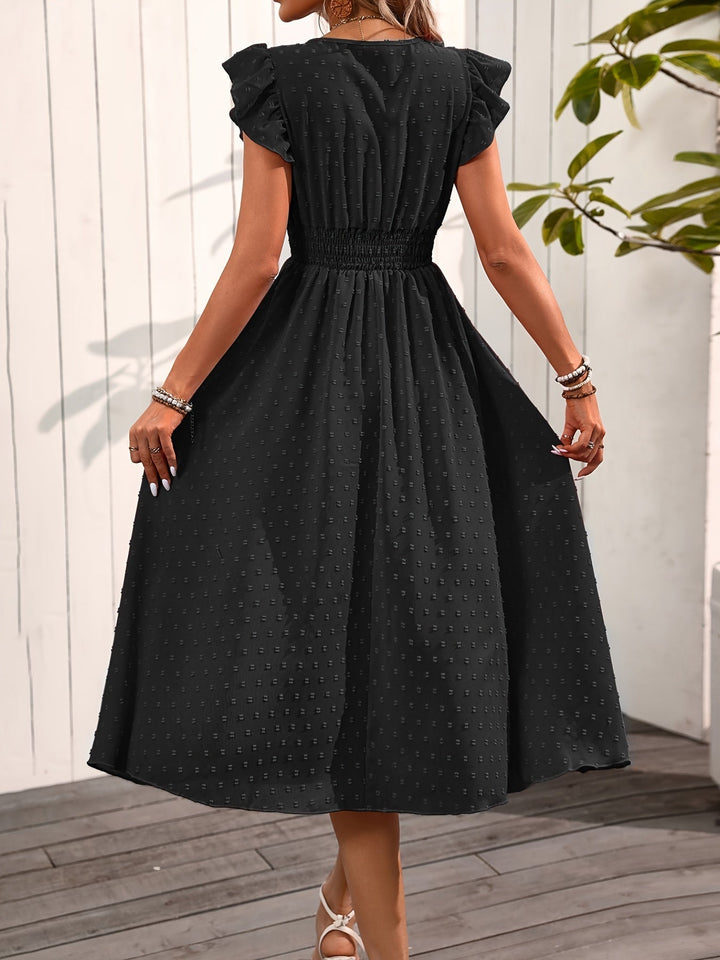 Red women's V-neck midi dress, ruffle sleeves, smocked waist, & dotted pattern. Flowy and elegant ladies fashion.