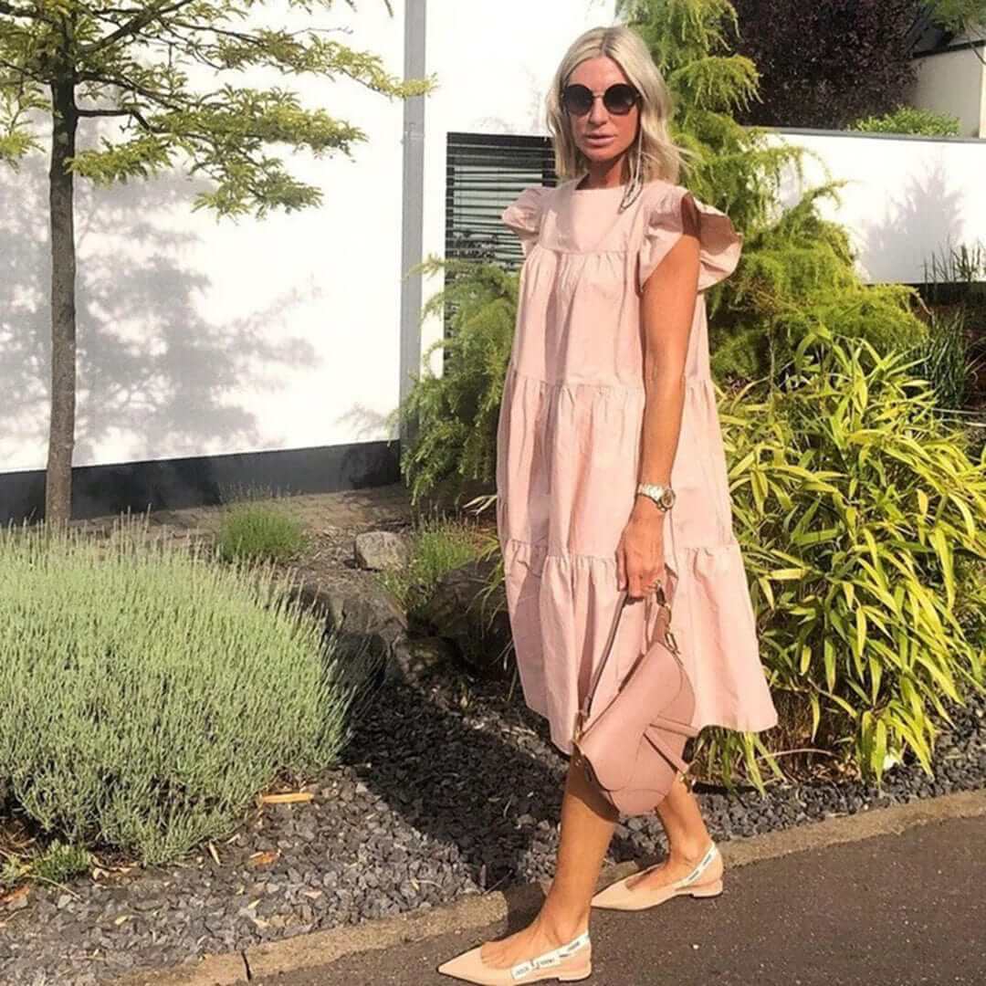 Summer women's elegant midi dress featuring beautiful ruffles. Sleeveless and breathable for warm weather fashion.