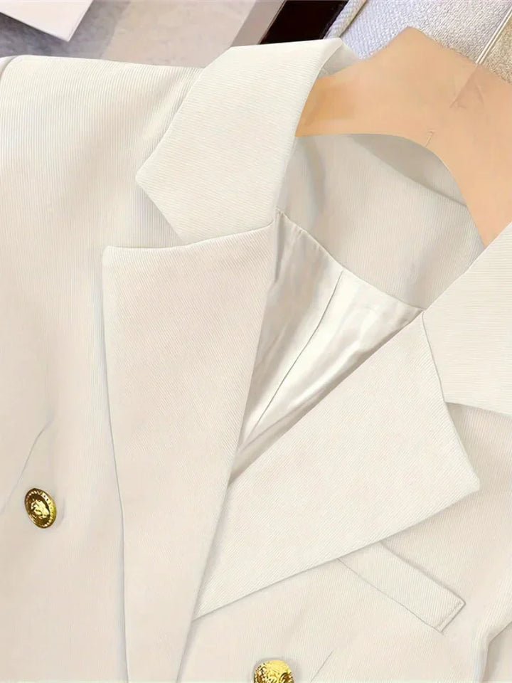Stylish women's outerwear blazer, slim design, adorned with luminous golden buttons for an elegant, professional touch.