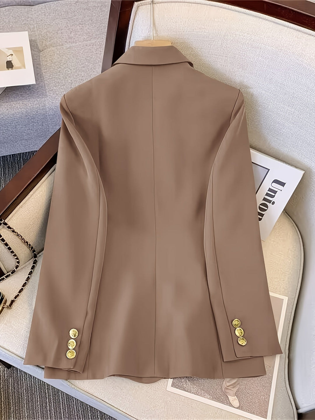 Black women's elegant blazer, slim fit, with eye-catching golden buttons for a polished, formal look.
