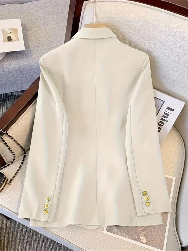 Sophisticated women's slim blazer with long sleeves and decorative golden buttons, a must-have for professional wear.