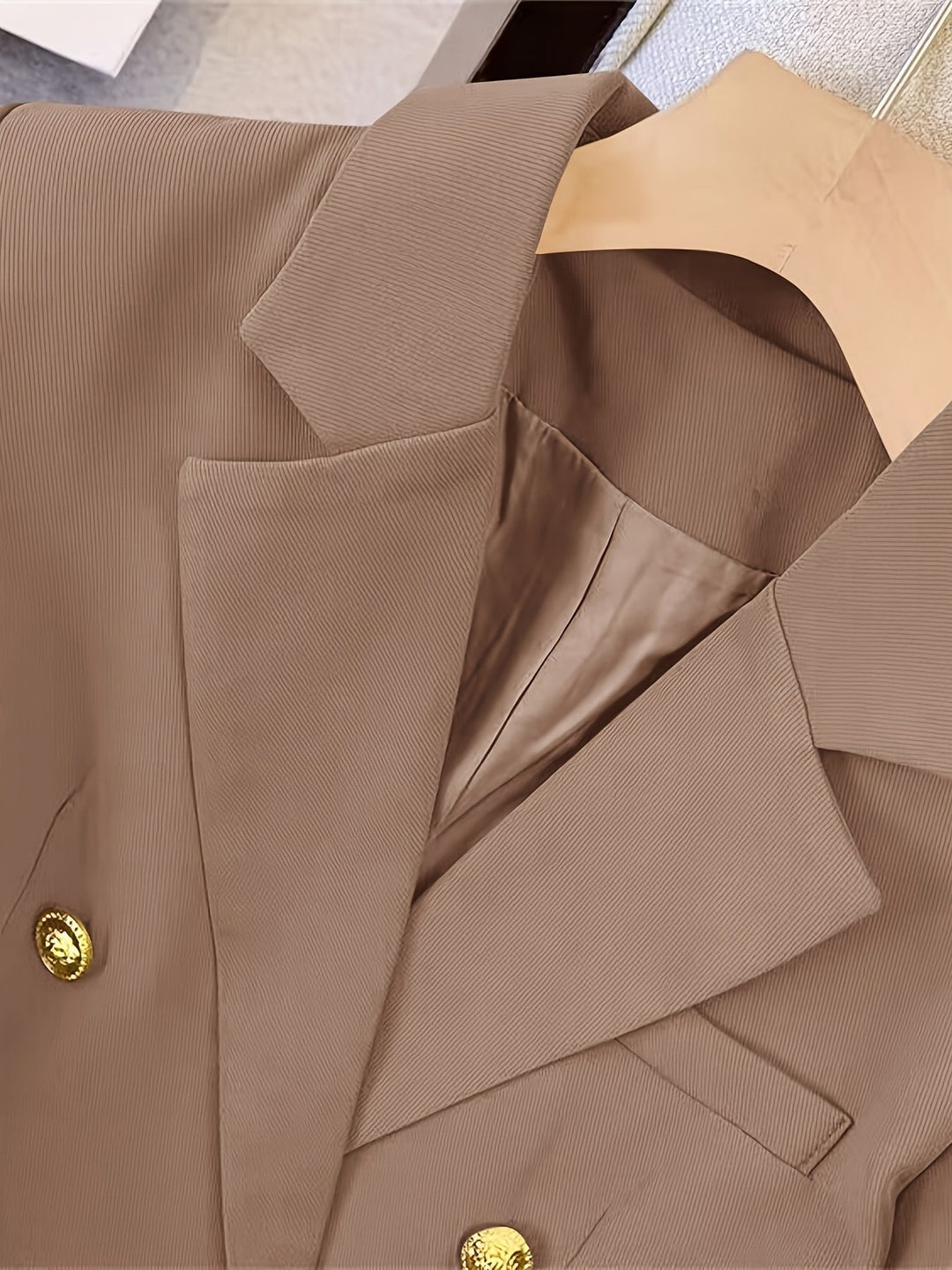 Elegant women's slim-fit blazer, detailed with golden buttons, offering a sleek and refined profile for any event.