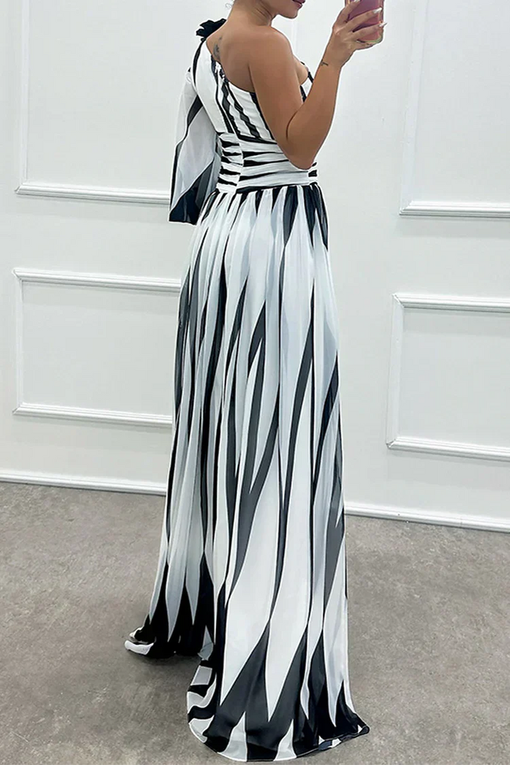 Flowy striped one-shoulder maxi dress for women, offering elegant comfort for beach holidays & summer fashion.