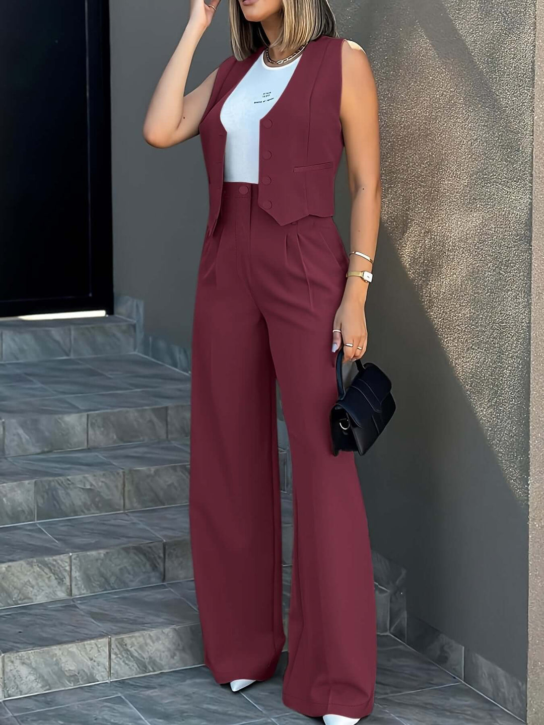 Front view of a women's sleek two-piece suit: tailored vest and flowing wide-leg trousers, business attire.