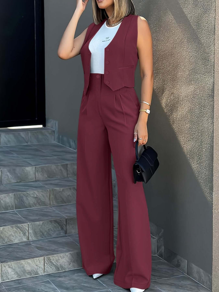 Front view of a women's sleek two-piece suit: tailored vest and flowing wide-leg trousers, business attire.