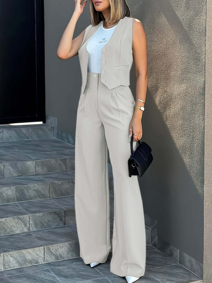 Full-length shot of women's tailored power suit: vest, wide-leg pants, for a sophisticated business look.