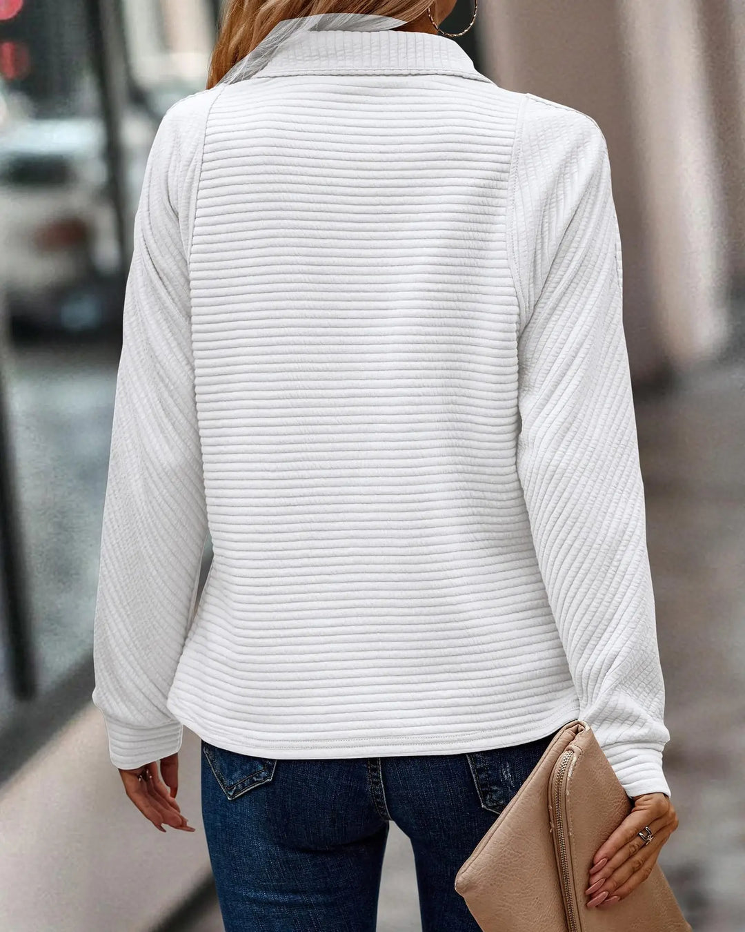 Luxurious soft knit women's jumper, V-neck and half-zip. Elegant long-sleeve top offering chic comfort.