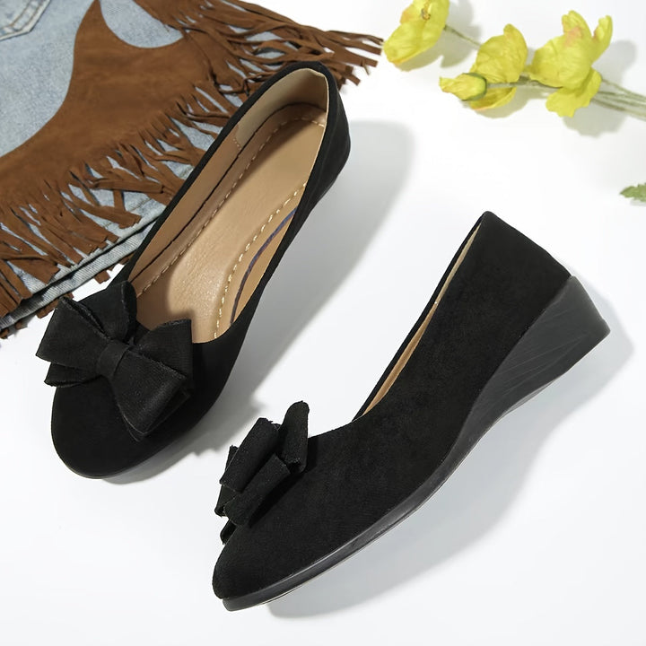 Elegant women's footwear: wedge ballet flats with a delightful bow.