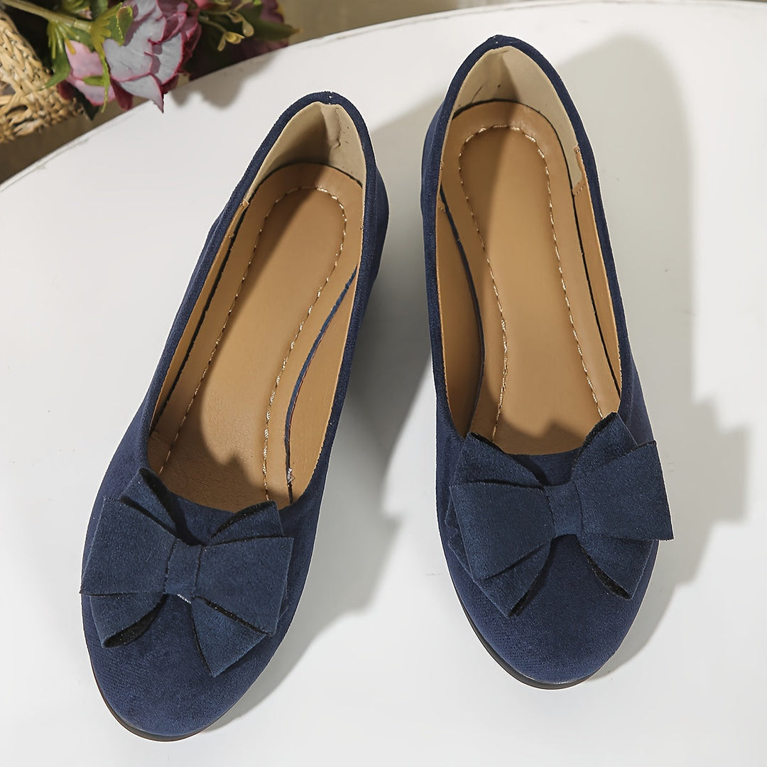 Comfortable women's ballet flats, featuring a wedge heel and pretty bow.