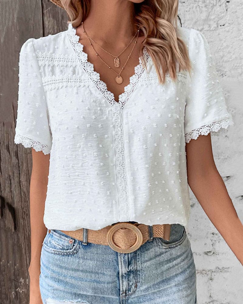 Women's elegant white textured V-neck blouse for summer. Breathable, comfortable, casual chic women's top.