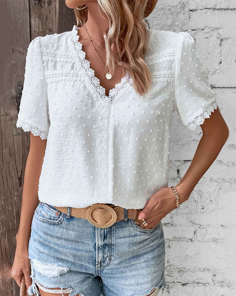 Close-up of elegant white textured V-neck blouse fabric, showcasing its breathable weave and summer comfort.