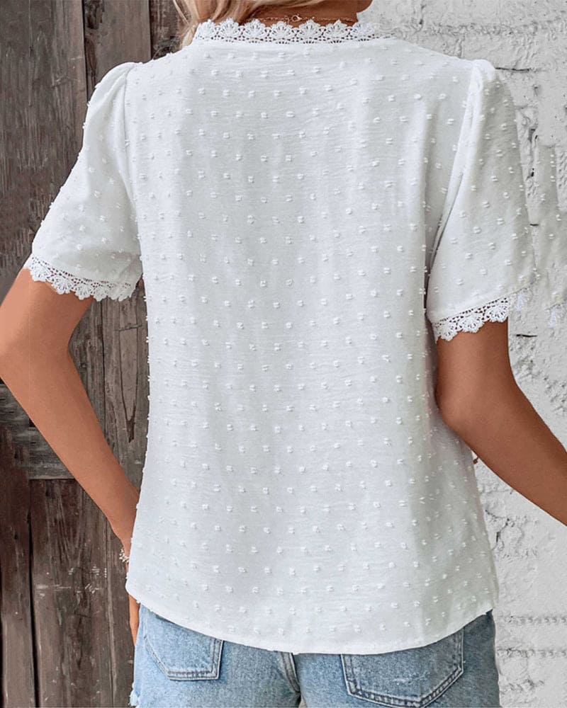 Women's white textured V-neck blouse styled for a casual chic summer outfit, perfect for warm weather and holidays.
