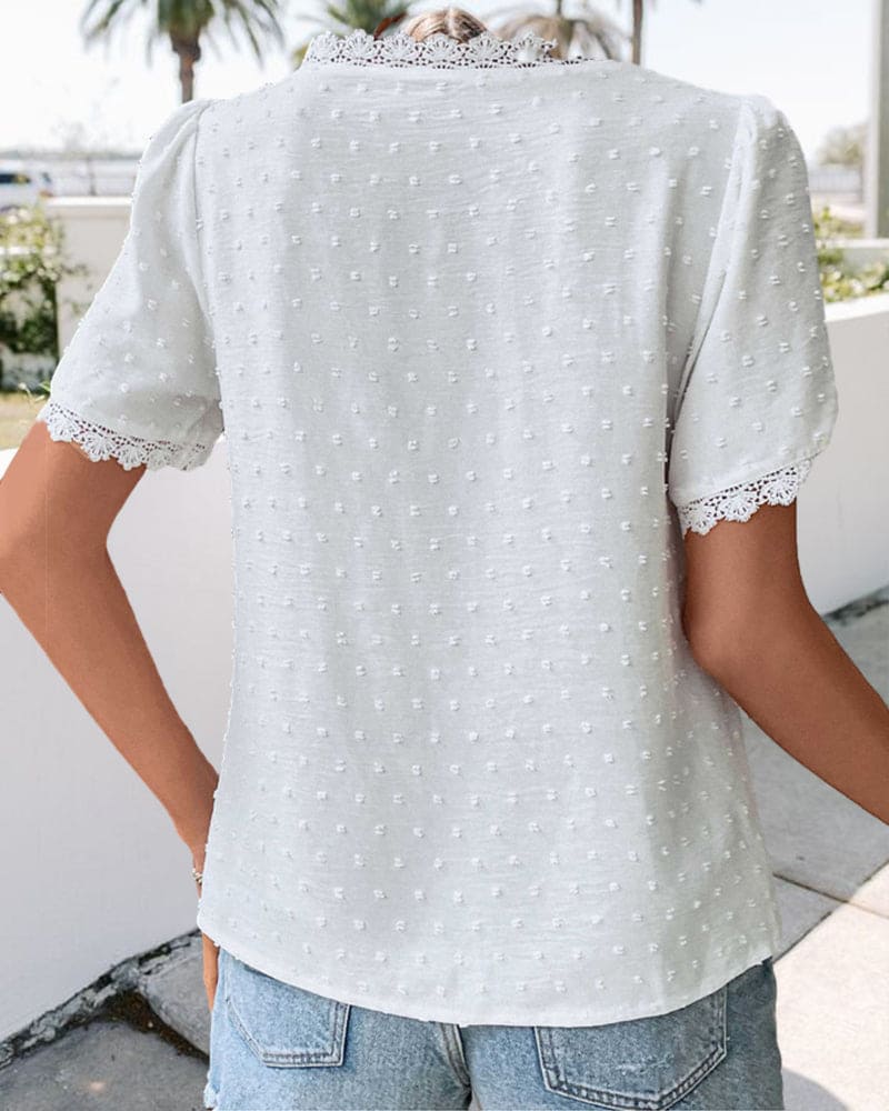Full shot of a women's elegant white textured V-neck blouse, a must-have for summer comfort and casual chic style.