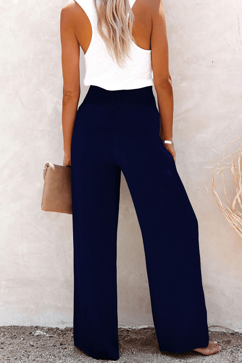 Elegant polyester women's wide leg trousers with prominent button closure, offering a comfortable loose fit.