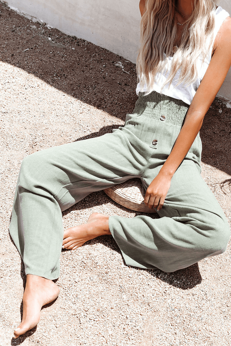 Close-up of elegant wide leg women's trousers, showcasing the chic button closure & comfortable fabric.