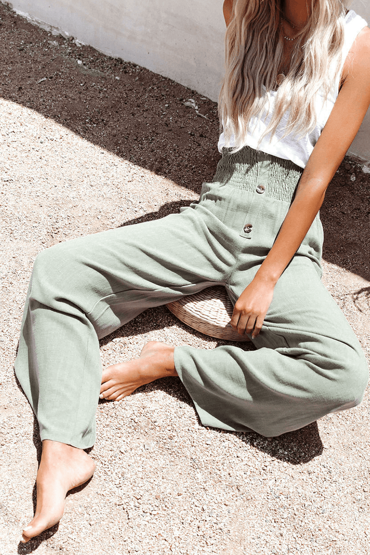 Close-up of elegant wide leg women's trousers, showcasing the chic button closure & comfortable fabric.