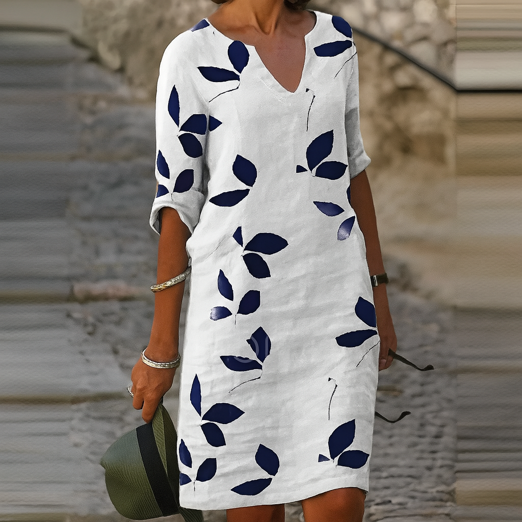 Chic women's leaf print summer dress. Flowy V-neck design with 3/4 sleeves, comfortable & casual knee-length style.