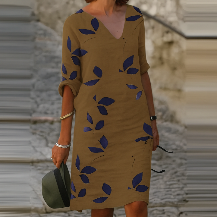 Elegant women's Eliza leaf print summer dress. Flowy, comfortable, knee-length, 3/4 sleeve V-neck. Ideal for vacation or casual wear.