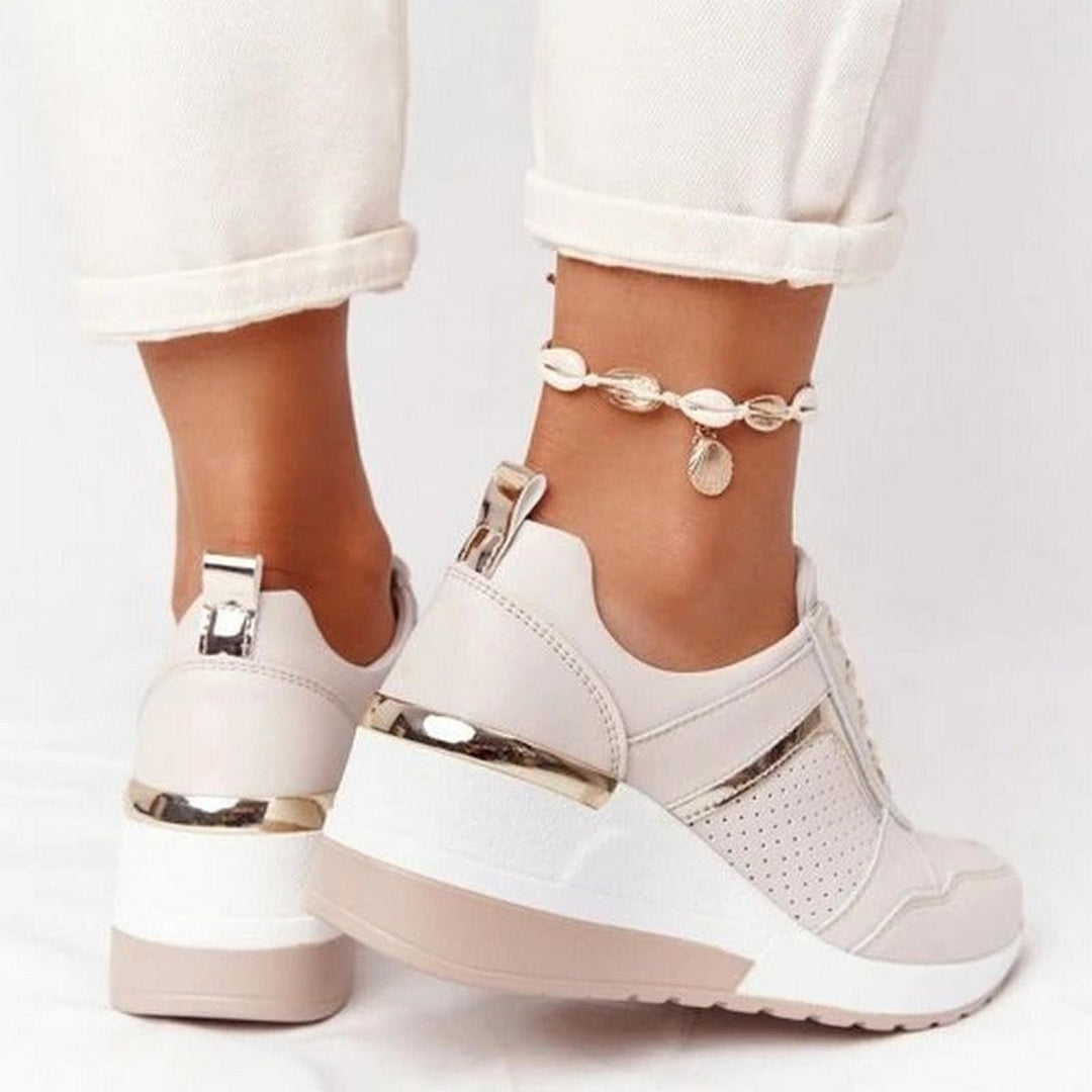 Fashionable women's hidden wedge sneakers, offering comfortable lift & modern casual style.