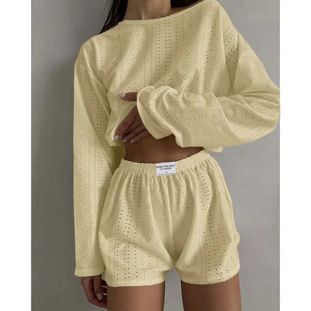 Two-piece women's eyelet knit set with a trendy crop top and comfy high-waisted shorts.