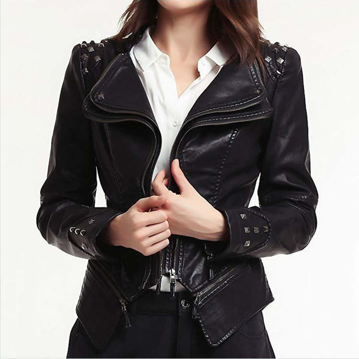 Women's fitted black leather biker jacket with silver stud detailing and rebel style.