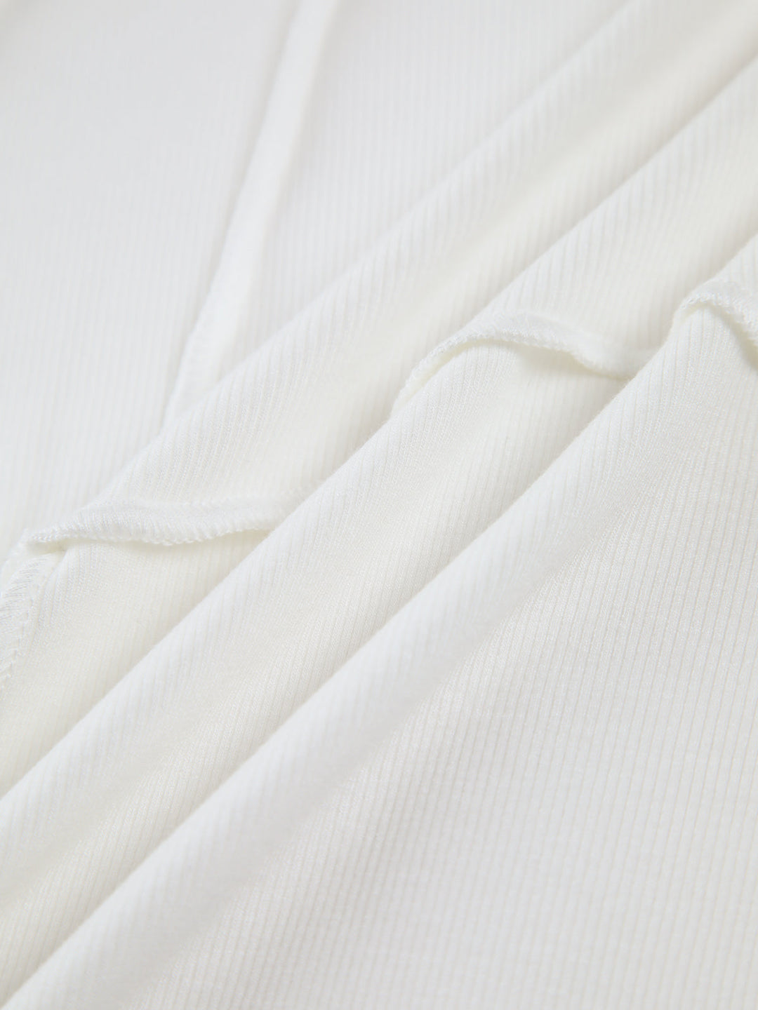 Sleek women's fitted long sleeve top featuring elegant raised seams, ideal for casual elegant or structured layering.