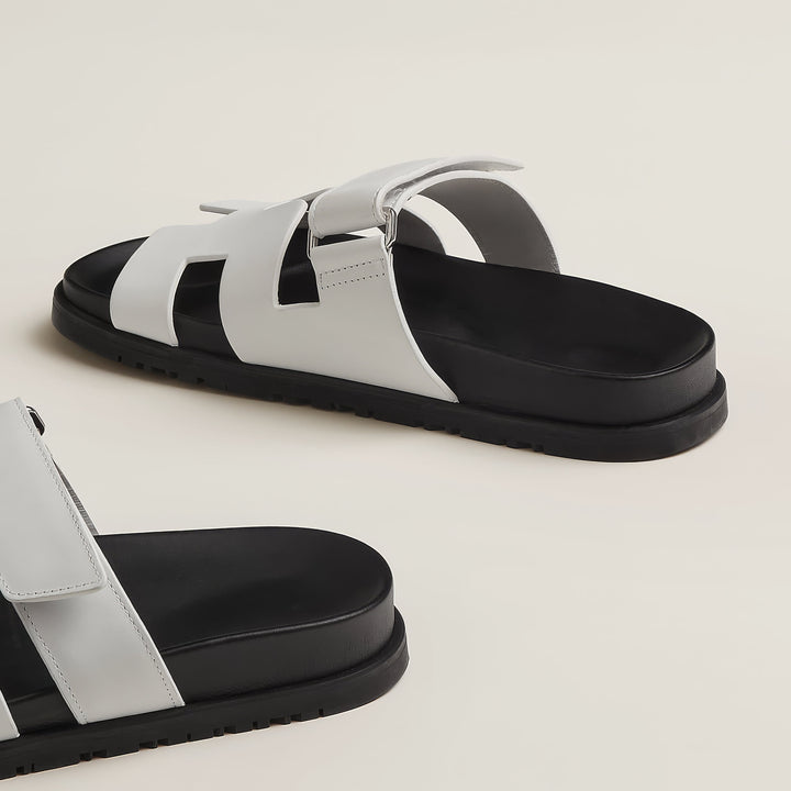 Modern women's flat sandals, slip-on comfort for summer casual footwear.
