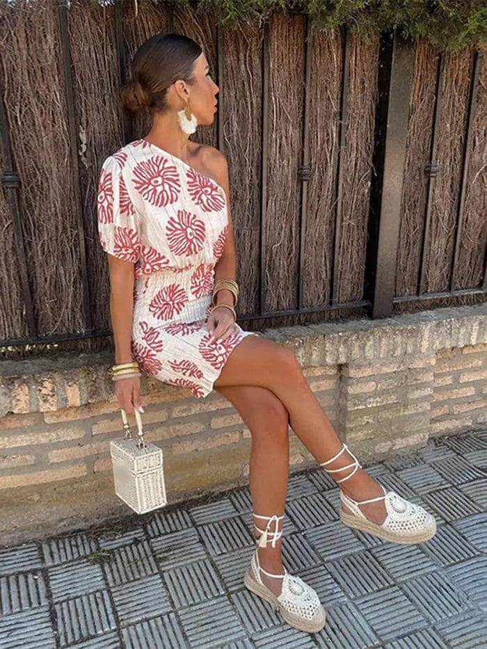 Women's flattering knitted dress with an elegant asymmetrical waistline. Modern and comfortable design.