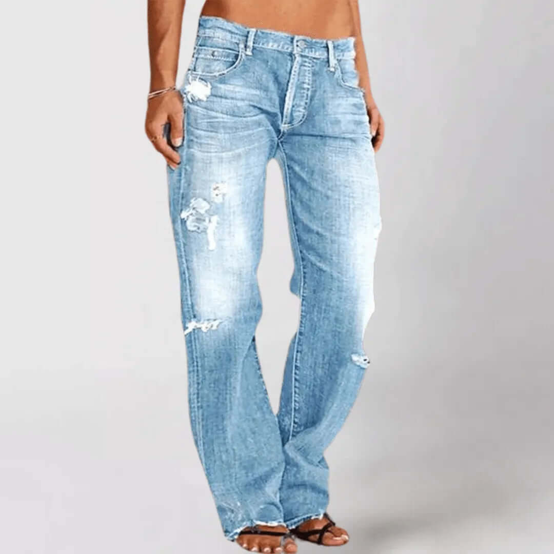 Women's distressed mid-rise stretch bootcut jeans. Casual & stylish denim for modern everyday fashion.