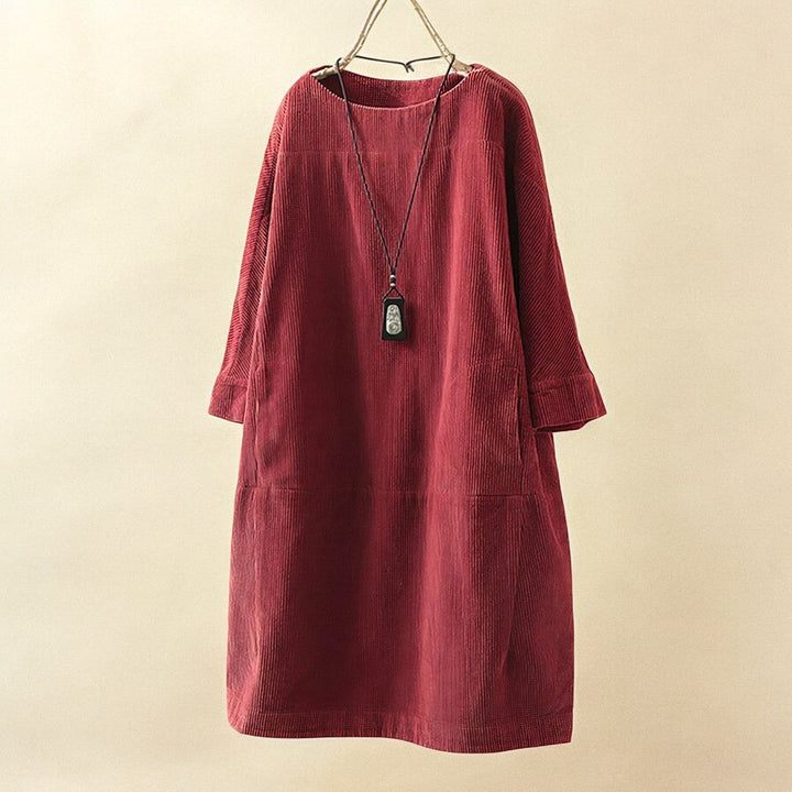 Flowy spring/summer women's dress, offering elegant style & comfortable tummy coverage.