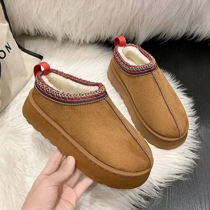 Women's fleece-lined slip-on mules, perfect for cozy winter wear. Comfortable indoor-outdoor cold weather footwear.