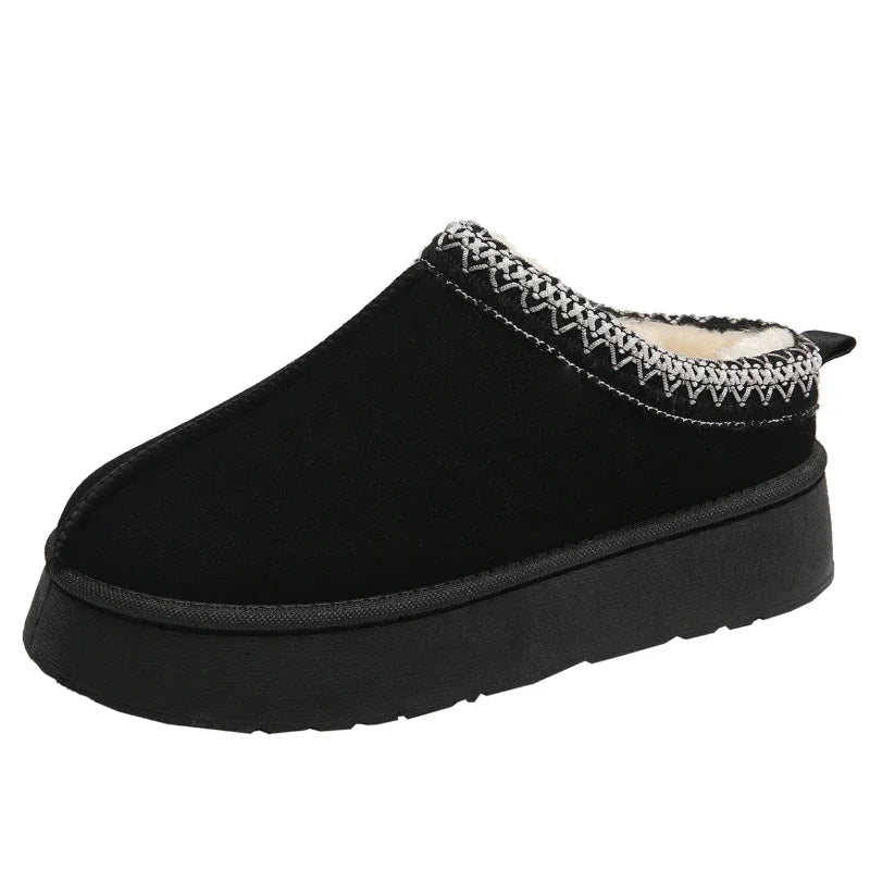 Woman wearing comfortable fleece-lined slip-on mules for women, enjoying cozy warmth indoors on a cold day.