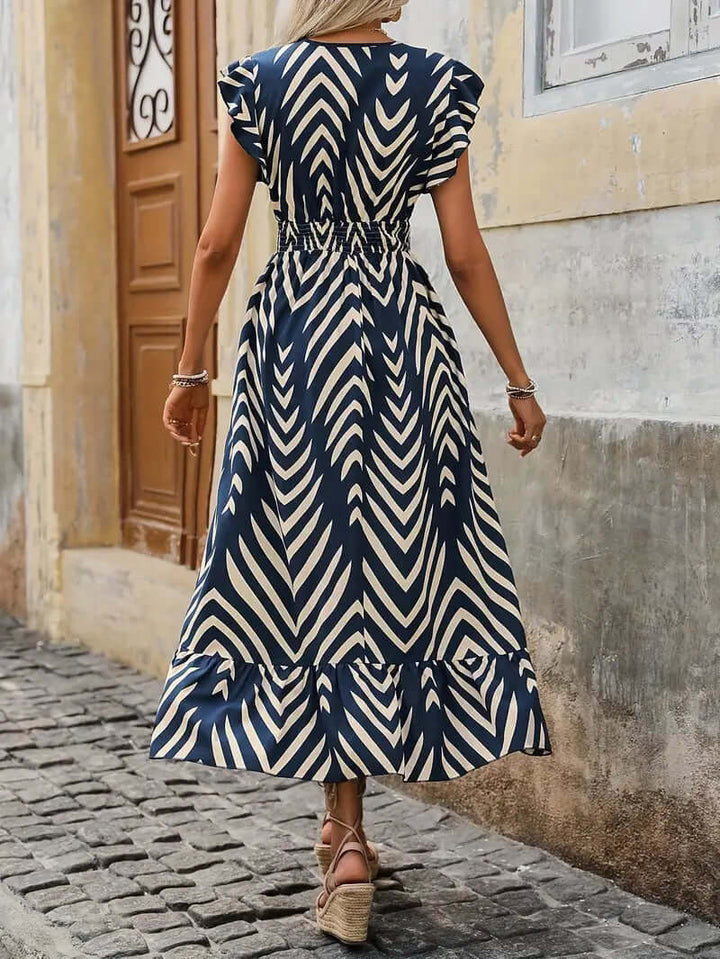 Chic women's floral print midi dress featuring a comfortable smocked waist. Perfect polyester dress for spring/summer wear.