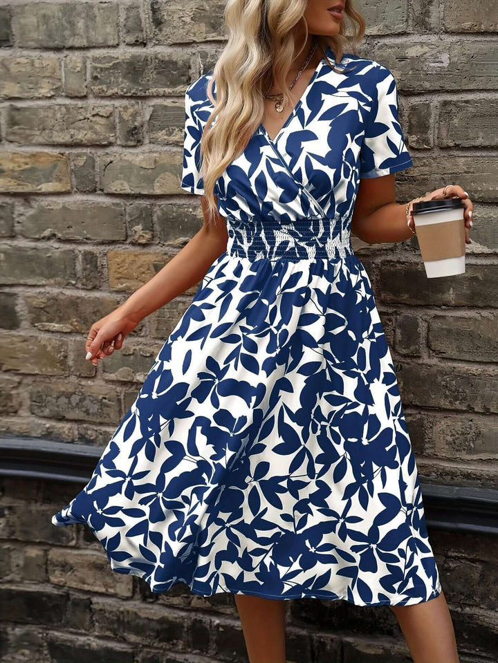 Full shot of women's elegant floral midi dress with smocked detail, ideal for spring fashion & summer.