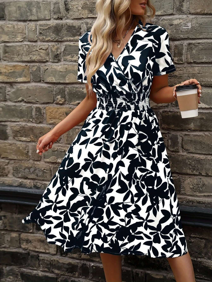 Flowy floral smocked midi dress for women, featuring a vibrant print. Comfortable and casual summer dress.