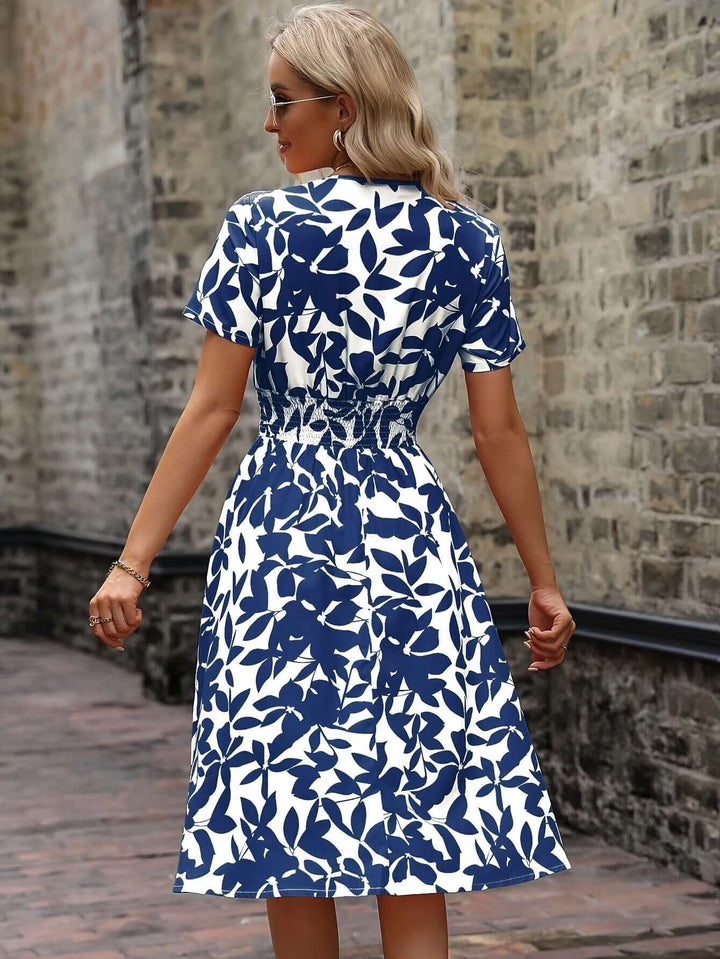 Detail of the vibrant floral pattern on a women's smocked midi dress. Enhances spring & summer style.